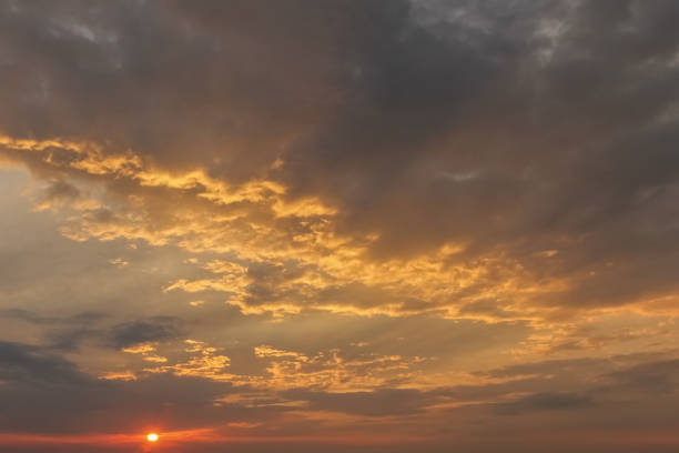 istock Dramatic sunset sky with orange colored clouds and last rays of the sun, colorful evening background 1138157380