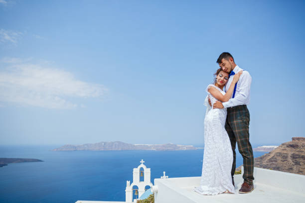 istock Bride and groom stand next to the sea 1138157454