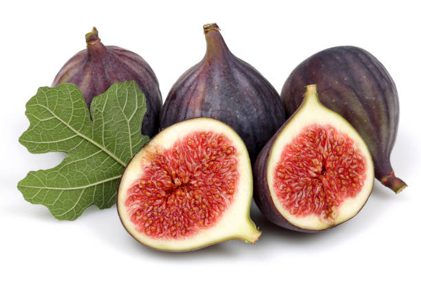 istock Fresh purple fig fruit and slices with leaf isolated 1138157638