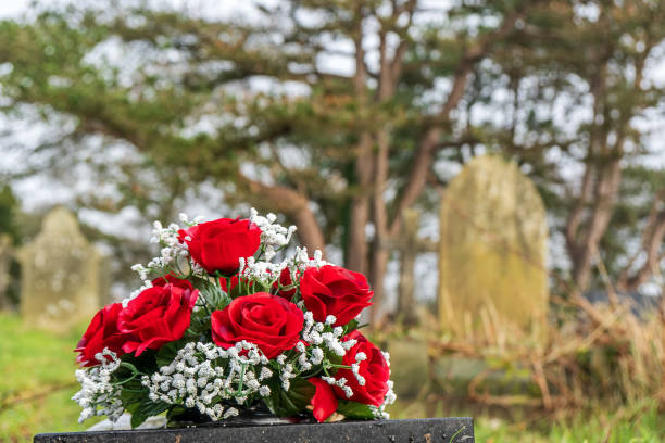 istock Churchyard cemetery gravestone with flowers 1138157671