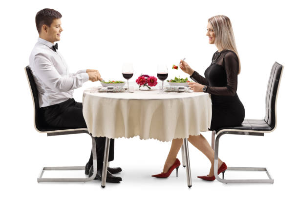 istock Young couple having salad and wine at a restaurant 1138158738