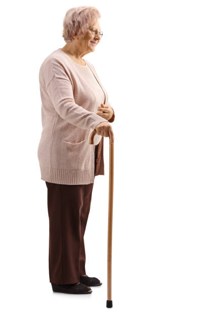istock Elderly woman standing with a cane 1138159067