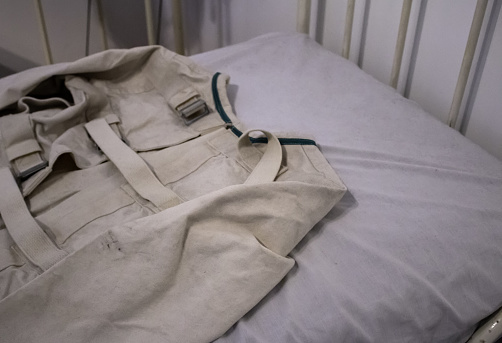 Straitjacket in psychiatric hospital, dementia and disease