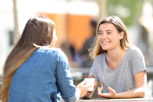 istock Happy women talking sitting in a park 1138161761