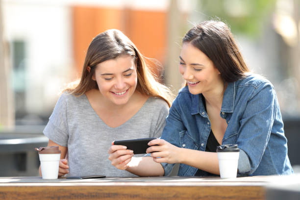 istock Two happy women watching media on smartphone 1138161877