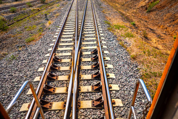 Railway train on hills on blue sky in country