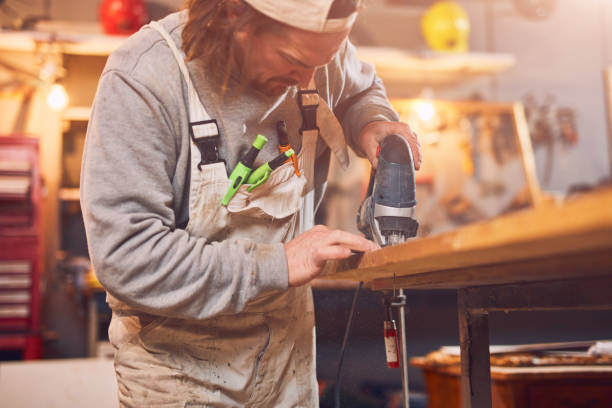 istock Male carpenter working on old wood in a retro vintage workshop. 1138162910
