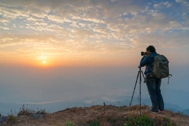 istock Photographer taking sunrise photo 1138167786