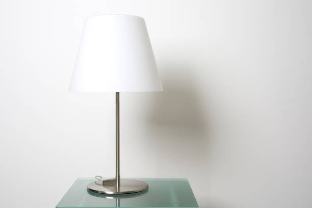 istock Lamp on glass table and white wall with copy space. 1138167826