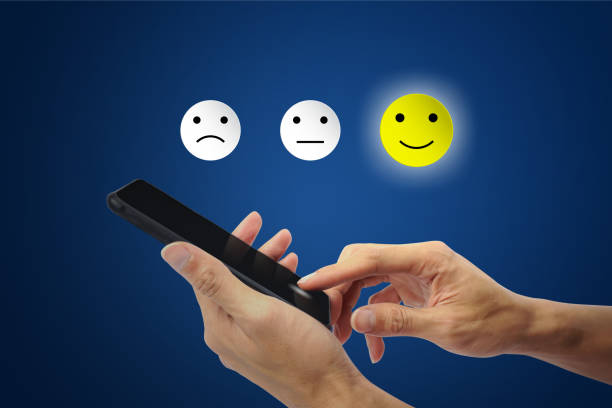 istock The client using hand choose happy face smile icon on smartphone. 1138168088