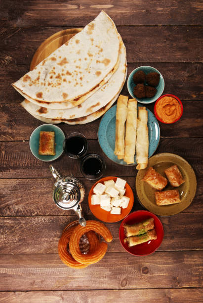 istock Middle eastern or arabic dishes and assorted meze, concrete rustic background. Turkish Bread or Turkish pizza. Dessert Baklava with pistachio. falafel with hommos.  Halal food. Lebanese cuisine 1138169573
