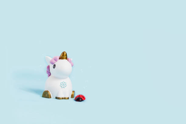 istock white toy unicorn and ladybug on a blue background 1138169819