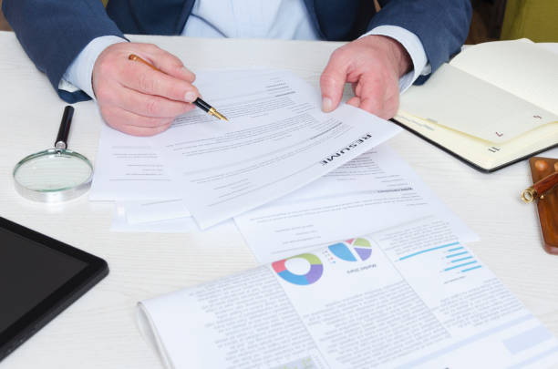 istock Professional headhunter reviewing resume at the desk and making decision before hiring employee 1138171094