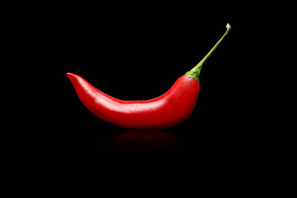 Red chilli peppers on black  background. stock photo