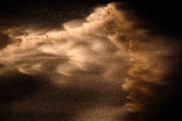 istock Golden sand explosion isolated on black background. Abstract sand cloud. 1138172121