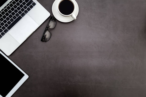 istock Workspace in office ,Black desk with blank notebook and other office supplies,Top view with copy space. 1138172763