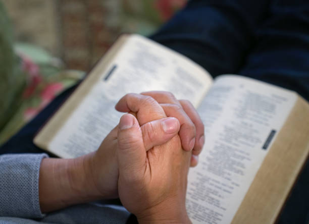 istock Praying with the Bible at the background 1138174430