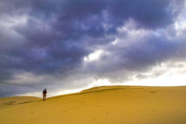 istock Explorer hiking up the desert mountain 1138174535