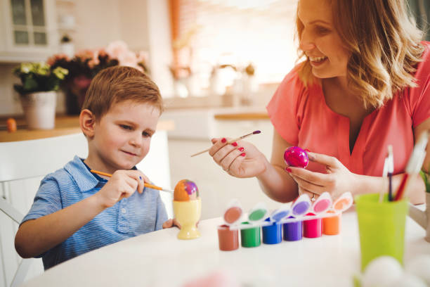 istock Happy Family Painting Easter Eggs 1138175791