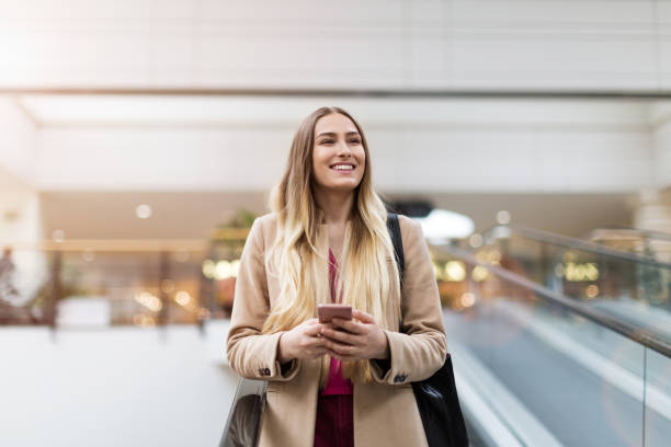 istock Young woman on escalator 1138177743