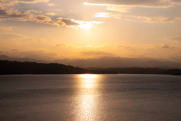 istock Beautiful sunset time. Glowing gold reflecting through the water surface. 1138178238