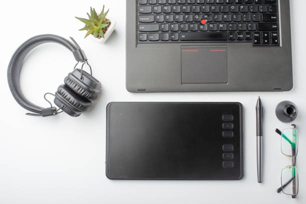 istock Top view of the workplace designer. Creative designer, graphics tablet, laptop, and accessories for the graphic designer.Flat lay.On a white background 1138179691