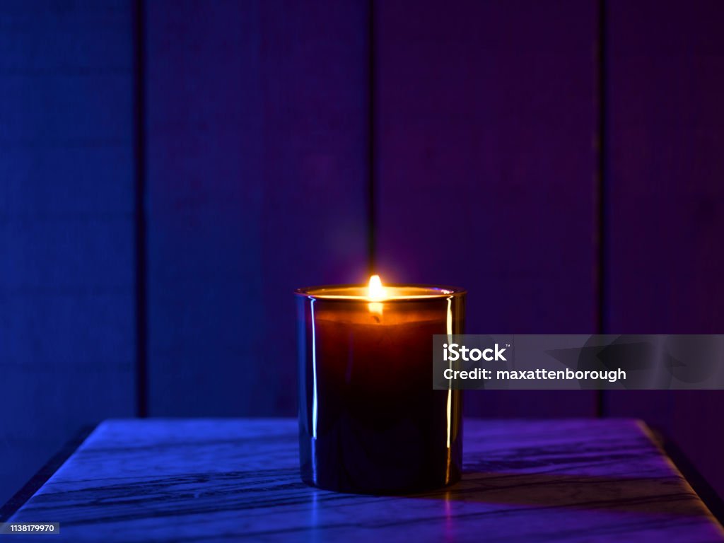 Scented Candle This is a lit scented candle to create a mood shot for yoga or massage. Candle Stock Photo