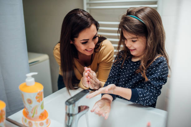 istock Woman washing hands with her daughter 1138180556