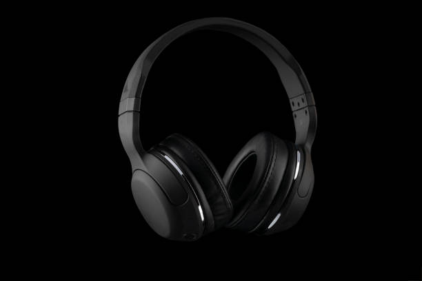 istock Black wireless headphones isolated on a black background. 1138180800