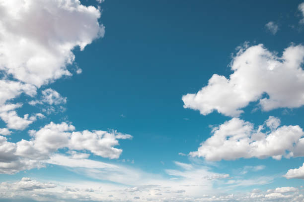Puffy Clouds Blue summer sky with fluffy white clouds. sky only stock pictures, royalty-free photos & images