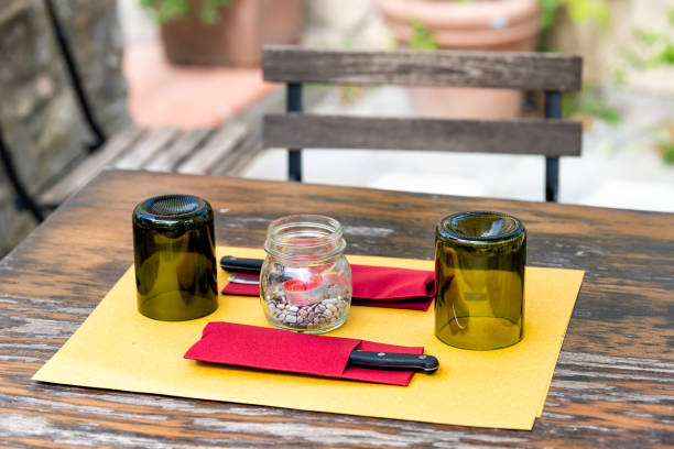 italy closeup of glasses upside down on empty restaurant table in outside in traditional style street cafe wooden seat romantic day - vignoni imagens e fotografias de stock