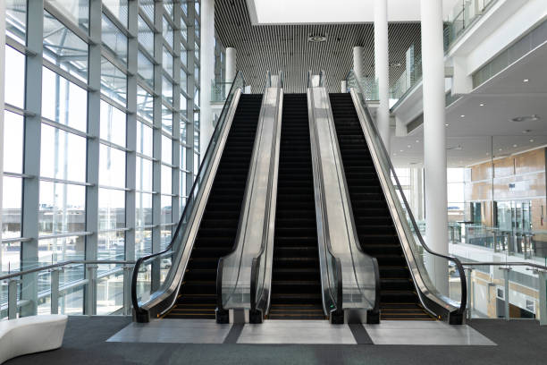 istock Front view of three modern escalators in a office lobby 1138184021