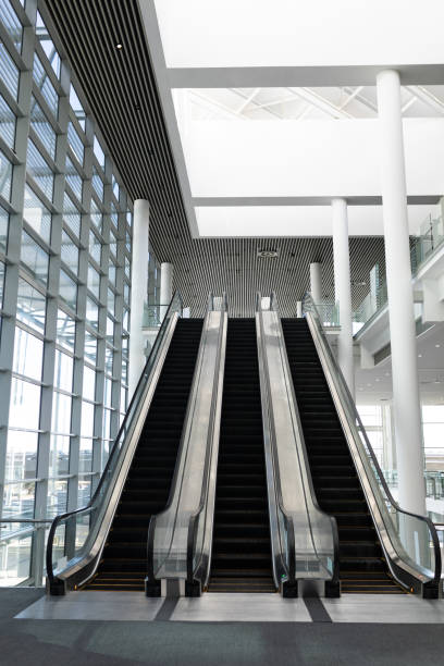 istock Front view of three modern escalators in a office lobby 1138184035