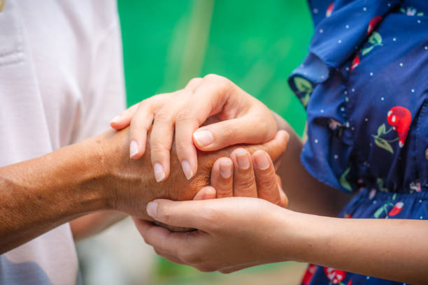 istock Asian senior and asian young holding hands. 1138184176