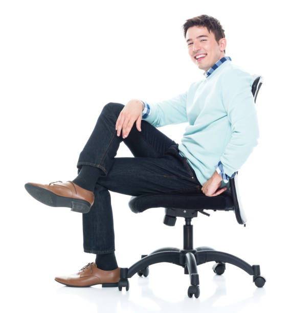 istock Handsome young man sitting and and being happy, side view 1138184419