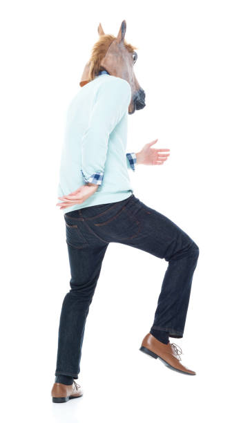 istock Man with horse mask is dancing 1138184481