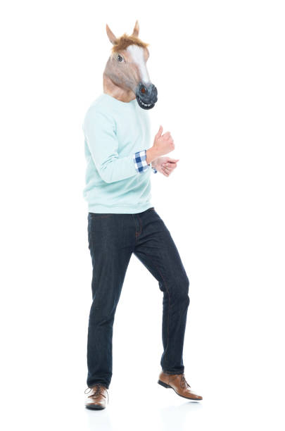 istock Man with horse mask and dancing 1138184591