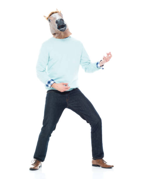 istock Man with horse mask doing air guitar 1138184603