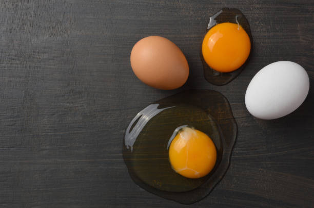 istock Set of brown and white eggs and egg yolks with copy space 1138184621