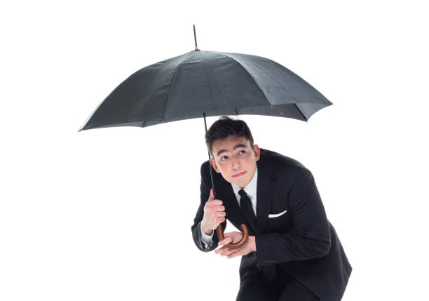 istock Handsome businessman holding an umbrella 1138184743