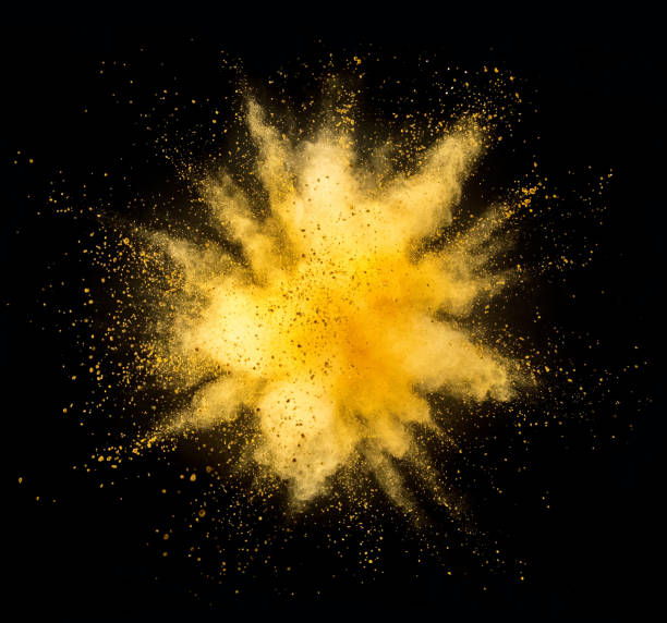 explosión de polvo dorado sobre fondo negro - amarillo color fotografías e imágenes de stock