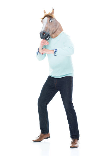 istock Man with horse mask in a fighting stance 1138184980