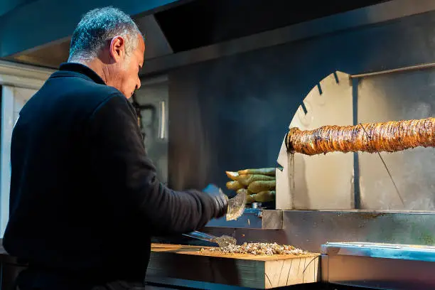 Preparing lamb fast food called kokoreç by chef