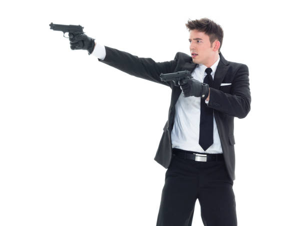 istock Handsome businessman holding a handgun 1138186306