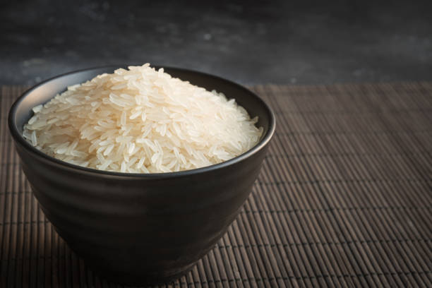 istock Steamed rice in bowl on black background. Copy space. 1138186356