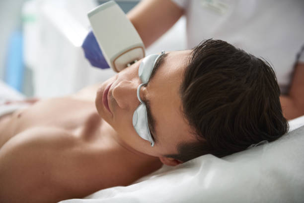istock Close up IPL epilation procedure of man face 1138186455