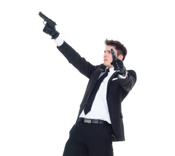 istock Handsome businessman holding a handgun 1138186542