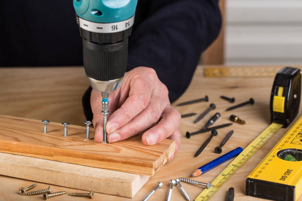 istock Carpenter with electric screwdriver. carpenter at handmade work 1138187565