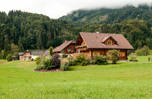 Modern holiday villa with wooden panels and large windows.