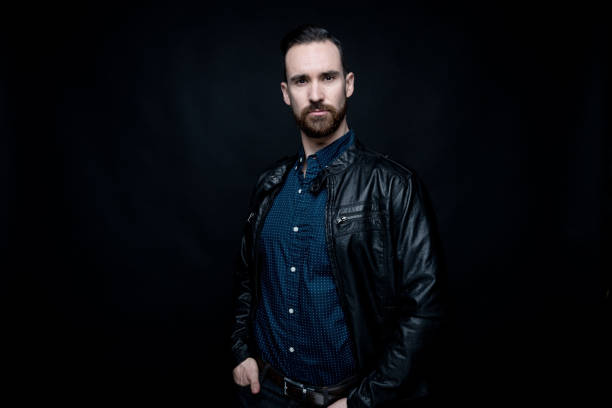 istock Handsome man wearing blue shirt and leather jacket 1138189539